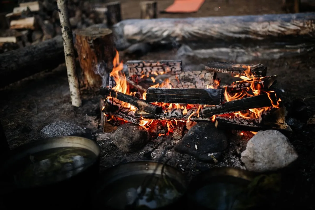 Sunken gas fire pit with stone cap lit at evening in Tuscany, Meridian Idaho